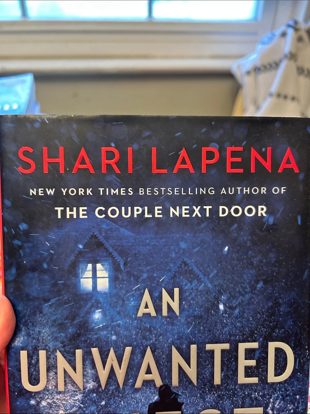 An Unwanted Guest by Shari Lapena Blue Hardcover Novel